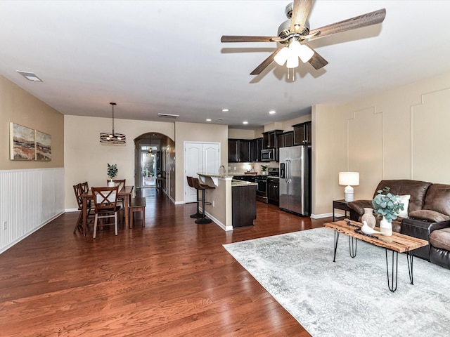 7325 Overmountain Dr, Rock Hill, SC 29732 - living area featuring arched walkways, a ceiling fan, dark wood-style flooring, and recessed lighting