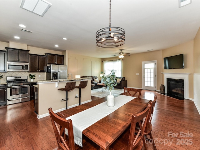7325 Overmountain Dr, Rock Hill, SC 29732 - dining area featuring ceiling fan, a fireplace with flush hearth, dark wood-type flooring, and recessed lighting