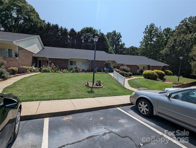 409 4th St SW, Conover, NC 28613 - ranch-style house with a front lawn, uncovered parking, and brick siding