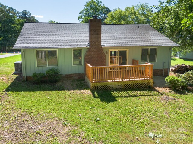 2011 20th Street Pl NE, Hickory, NC 28601 - back of house with roof with shingles, a wooden deck, board and batten siding, a chimney, and a yard