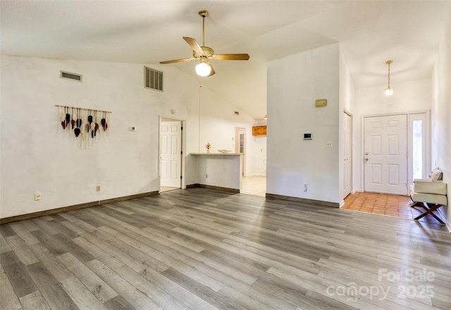 2011 20th Street Pl NE, Hickory, NC 28601 - unfurnished living room with wood finished floors, high vaulted ceiling, a ceiling fan, and baseboards