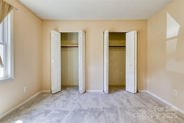2011 20th Street Pl NE, Hickory, NC 28601 - unfurnished bedroom featuring multiple closets, carpet floors, and baseboards