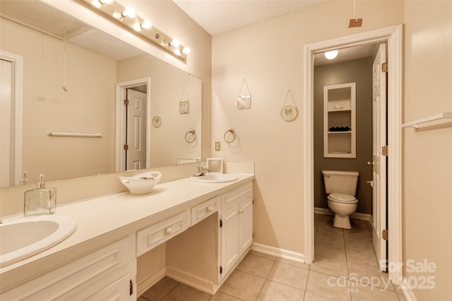 2011 20th Street Pl NE, Hickory, NC 28601 - full bathroom featuring double vanity, tile patterned floors, toilet, and a textured ceiling