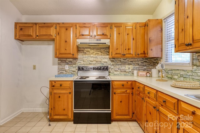 2011 20th Street Pl NE, Hickory, NC 28601 - kitchen with range with electric stovetop, under cabinet range hood, light countertops, tasteful backsplash, and brown cabinets