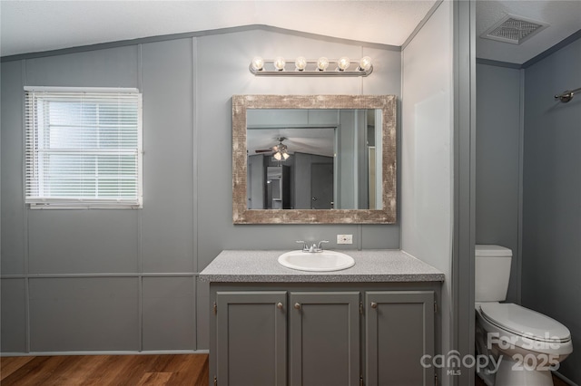 376 Puzzle Creek Rd, Bostic, NC 28018 - bathroom with vaulted ceiling, toilet, ceiling fan, vanity, and wood finished floors