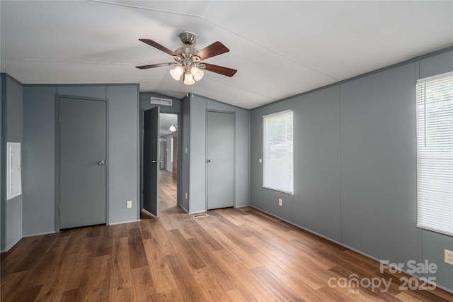376 Puzzle Creek Rd, Bostic, NC 28018 - unfurnished bedroom with lofted ceiling, wood finished floors, multiple closets, and ceiling fan