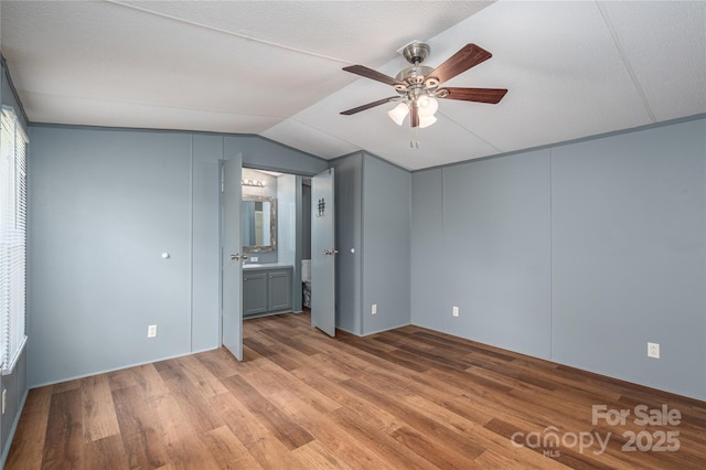 376 Puzzle Creek Rd, Bostic, NC 28018 - unfurnished bedroom featuring lofted ceiling, light wood-style floors, ensuite bathroom, and a ceiling fan