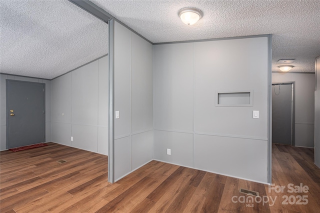 376 Puzzle Creek Rd, Bostic, NC 28018 - unfurnished room with a textured ceiling, a decorative wall, and wood finished floors