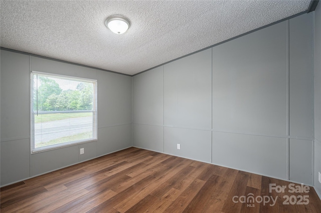 376 Puzzle Creek Rd, Bostic, NC 28018 - unfurnished room featuring a decorative wall, wood finished floors, and a textured ceiling