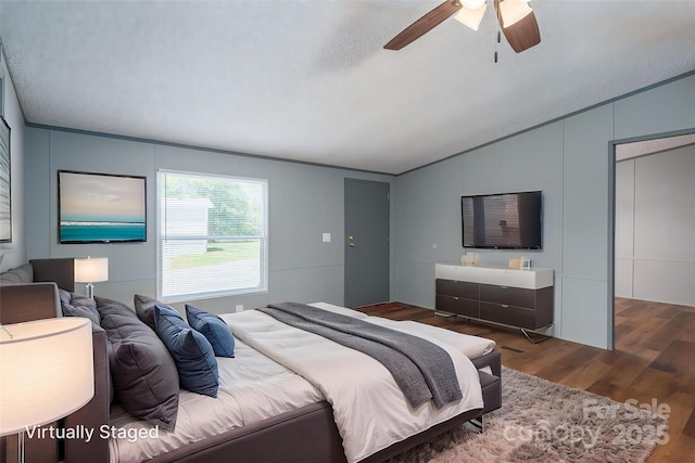 376 Puzzle Creek Rd, Bostic, NC 28018 - bedroom with lofted ceiling, wood finished floors, ceiling fan, a decorative wall, and a textured ceiling