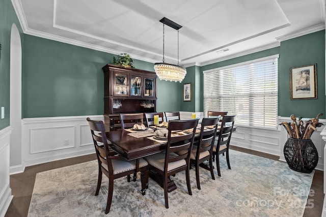 2414 Madeira Cir, Waxhaw, NC 28173 - dining area with a wainscoted wall, wood finished floors, ornamental molding, a tray ceiling, and arched walkways
