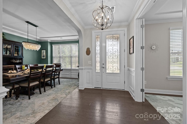 2414 Madeira Cir, Waxhaw, NC 28173 - entrance foyer featuring a chandelier, healthy amount of natural light, dark wood-style floors, ornamental molding, and wainscoting