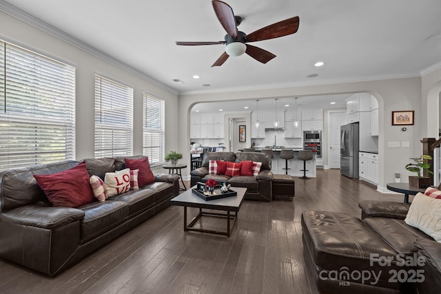2414 Madeira Cir, Waxhaw, NC 28173 - living area with arched walkways, a ceiling fan, ornamental molding, dark wood-style floors, and recessed lighting