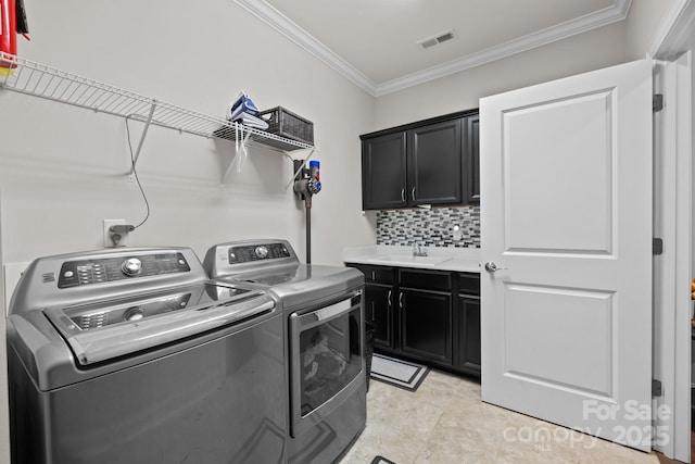 2414 Madeira Cir, Waxhaw, NC 28173 - laundry room featuring washing machine and clothes dryer, cabinet space, and crown molding
