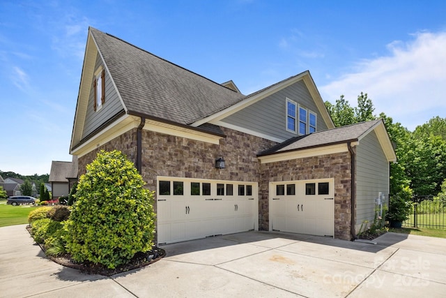 2414 Madeira Cir, Waxhaw, NC 28173 - view of property exterior with stone siding, concrete driveway, and a shingled roof
