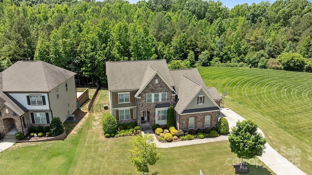 2414 Madeira Cir, Waxhaw, NC 28173 - view of front of house with stone siding, a front yard, and a forest view
