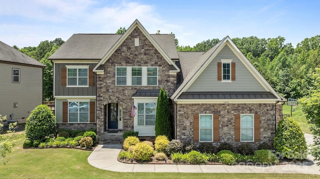 2414 Madeira Cir, Waxhaw, NC 28173 - craftsman house with stone siding, a front yard, a standing seam roof, and a shingled roof
