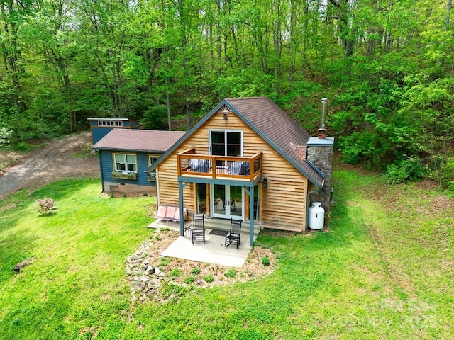 406 Poker Branch Rd, Sylva, NC 28779 - back of house featuring a lawn, a patio area, french doors, a deck, and a chimney