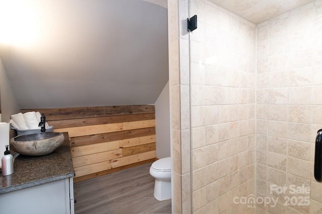 406 Poker Branch Rd, Sylva, NC 28779 - full bath featuring wood finished floors, toilet, tiled shower, wood walls, and vanity