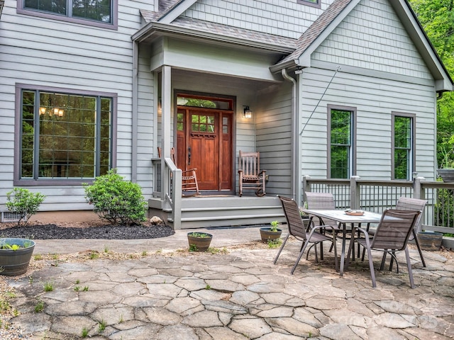 property entrance with outdoor dining area and a patio area