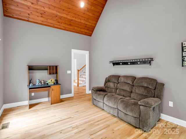 living room featuring wood finished floors, baseboards, high vaulted ceiling, wooden ceiling, and stairway
