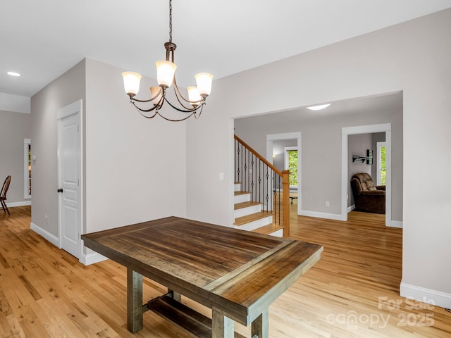 dining room with light wood-type flooring, baseboards, a chandelier, stairs, and recessed lighting