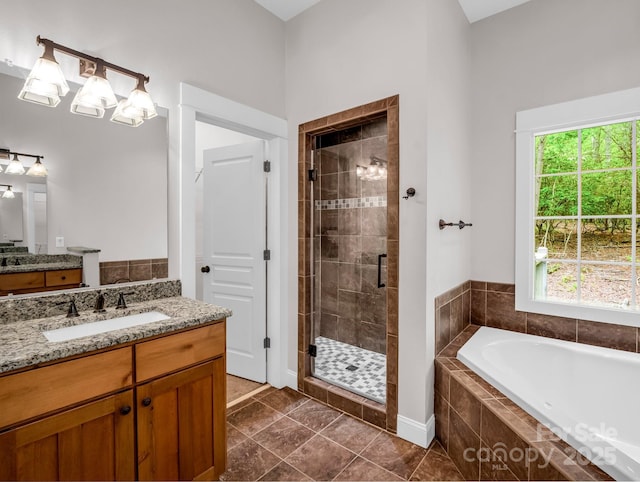 full bathroom featuring a stall shower, a garden tub, vanity, and tile patterned flooring