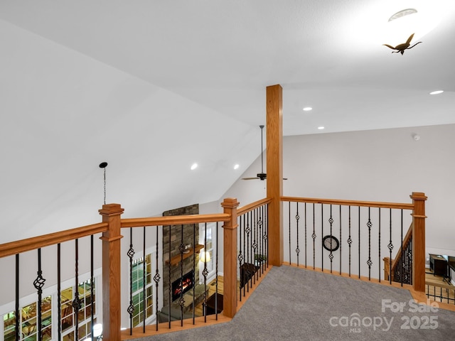 hall with recessed lighting, an upstairs landing, lofted ceiling, and carpet