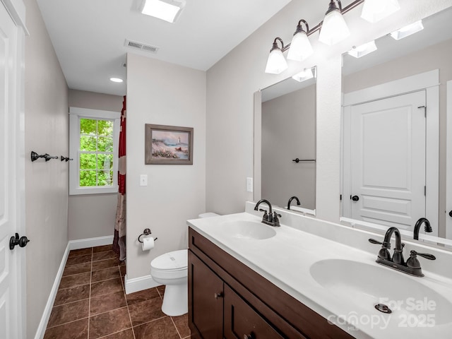 bathroom featuring toilet, baseboards, tile patterned floors, double vanity, and a shower with shower curtain