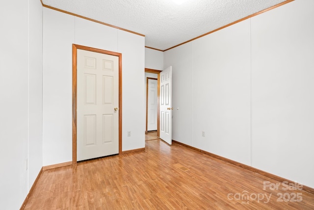 6822 Zelda Dr, Catawba, NC 28609 - unfurnished room featuring crown molding, light wood-style floors, a textured ceiling, and baseboards