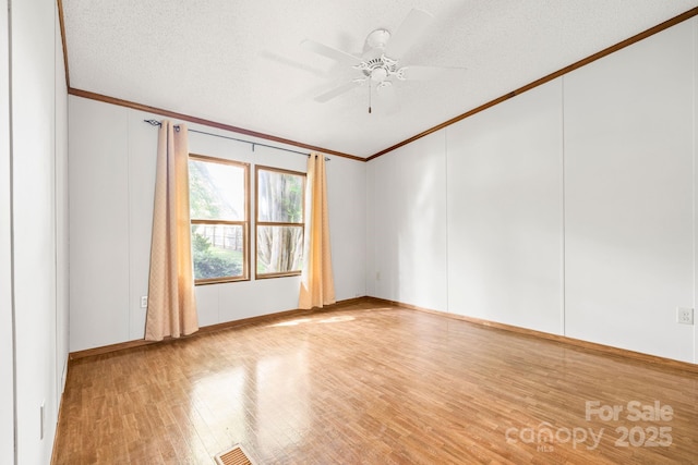 6822 Zelda Dr, Catawba, NC 28609 - spare room with crown molding, wood finished floors, ceiling fan, a textured ceiling, and baseboards