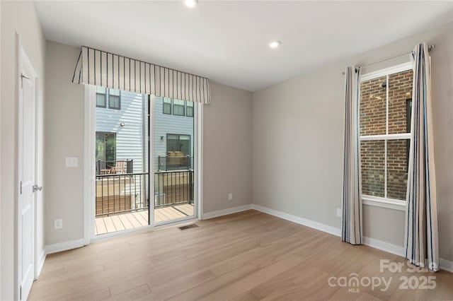 spare room with light wood-style flooring, baseboards, and recessed lighting