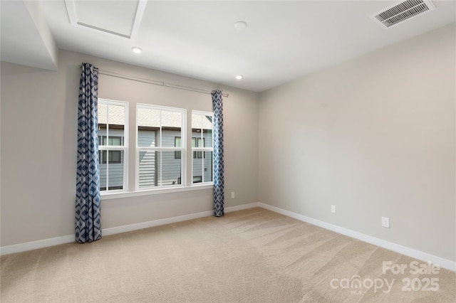 spare room featuring carpet floors, baseboards, recessed lighting, and attic access