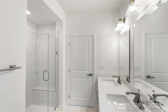 full bath with a marble finish shower and double vanity