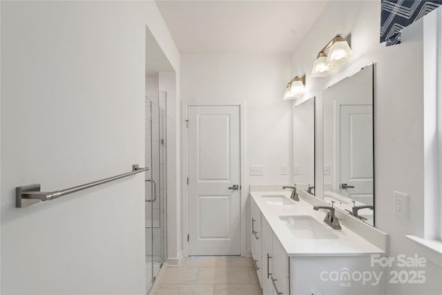 bathroom with marble finish flooring, a stall shower, and double vanity