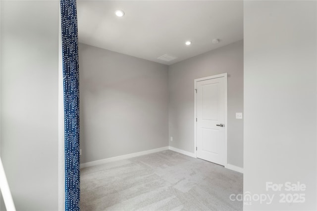 carpeted empty room with baseboards, recessed lighting, and a smoke detector