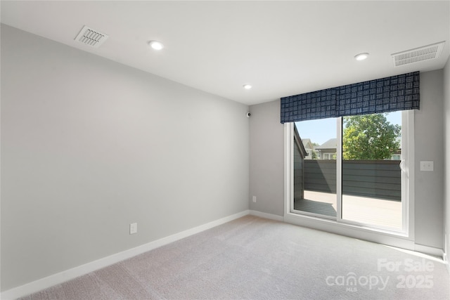spare room with light carpet, baseboards, and recessed lighting