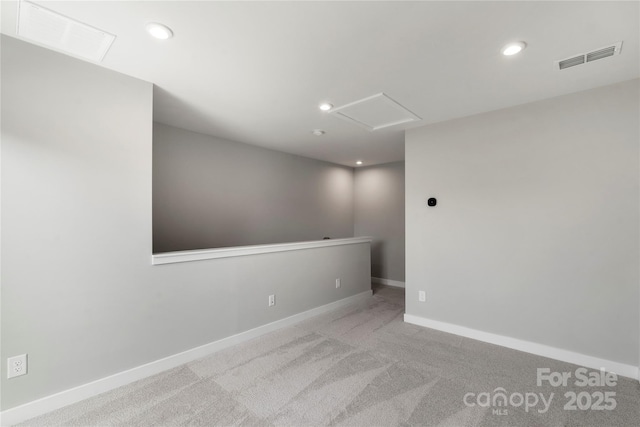 empty room with attic access, carpet flooring, baseboards, and recessed lighting