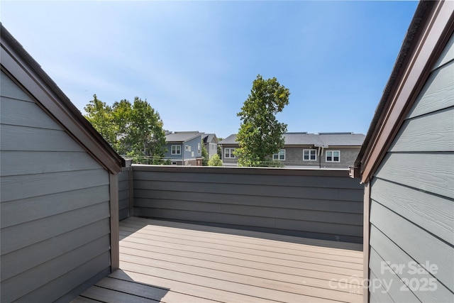 wooden deck featuring a residential view