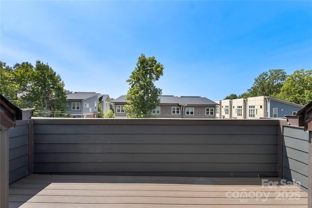 wooden deck featuring a residential view