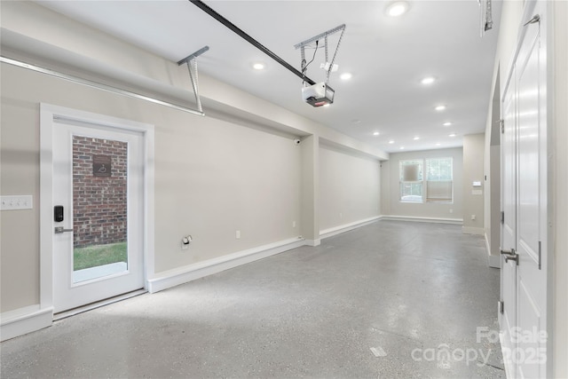 garage featuring a garage door opener, recessed lighting, and baseboards