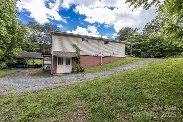 102 Lanier St, Mount Holly, NC 28120 - rear view of property featuring a yard and a carport