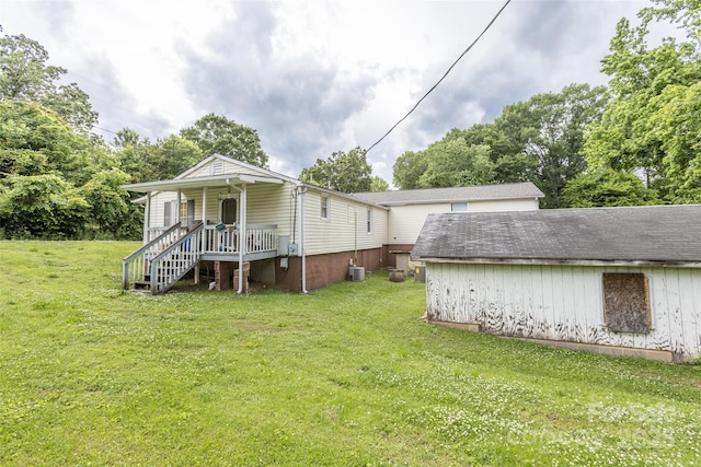 102 Lanier St, Mount Holly, NC 28120 - rear view of property with covered porch, a yard, stairway, and view of wooded area