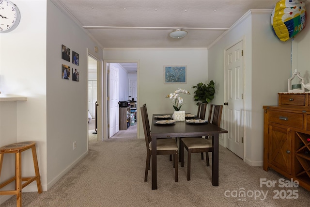102 Lanier St, Mount Holly, NC 28120 - dining space featuring light colored carpet, crown molding, and baseboards