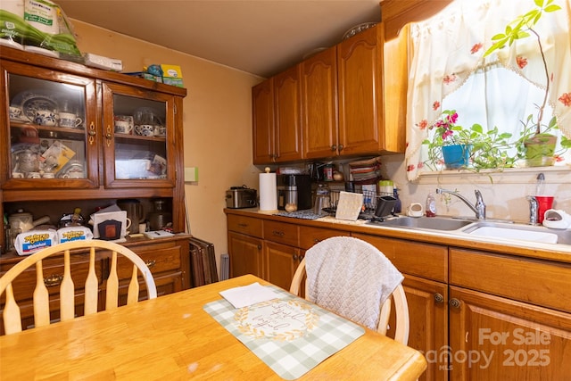 102 Lanier St, Mount Holly, NC 28120 - kitchen with a sink, light countertops, and brown cabinets