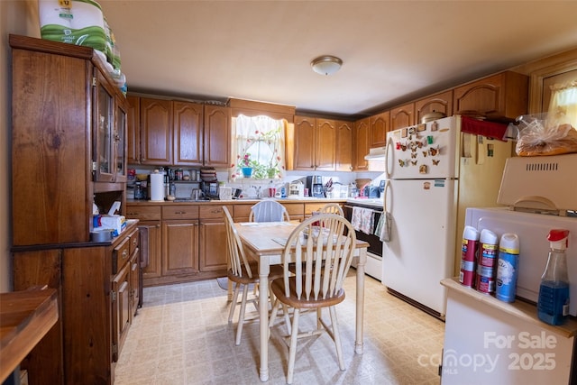 102 Lanier St, Mount Holly, NC 28120 - kitchen featuring brown cabinets, freestanding refrigerator, electric stove, and under cabinet range hood