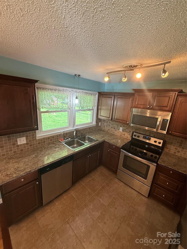 1303 Rambling Acres Cir, Lenoir, NC 28645 - kitchen with stainless steel appliances, a sink, decorative backsplash, a textured ceiling, and light tile patterned floors