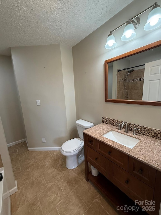 1303 Rambling Acres Cir, Lenoir, NC 28645 - bathroom featuring vanity, toilet, a textured ceiling, and tiled shower
