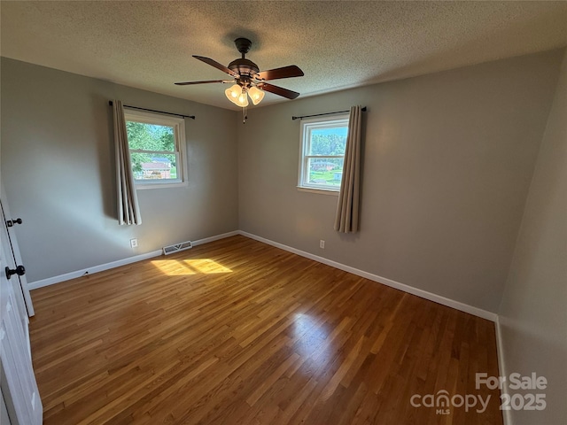 1303 Rambling Acres Cir, Lenoir, NC 28645 - unfurnished room with plenty of natural light, wood finished floors, a textured ceiling, and baseboards