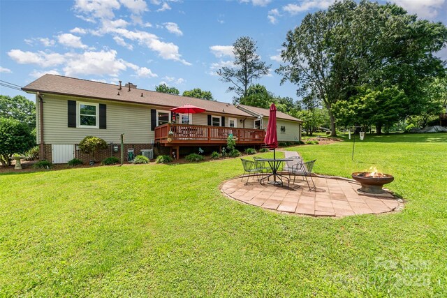 2401 Hoffman St, Gastonia, NC 28054 - back of property featuring a fire pit, a wooden deck, a patio, a yard, and cooling unit